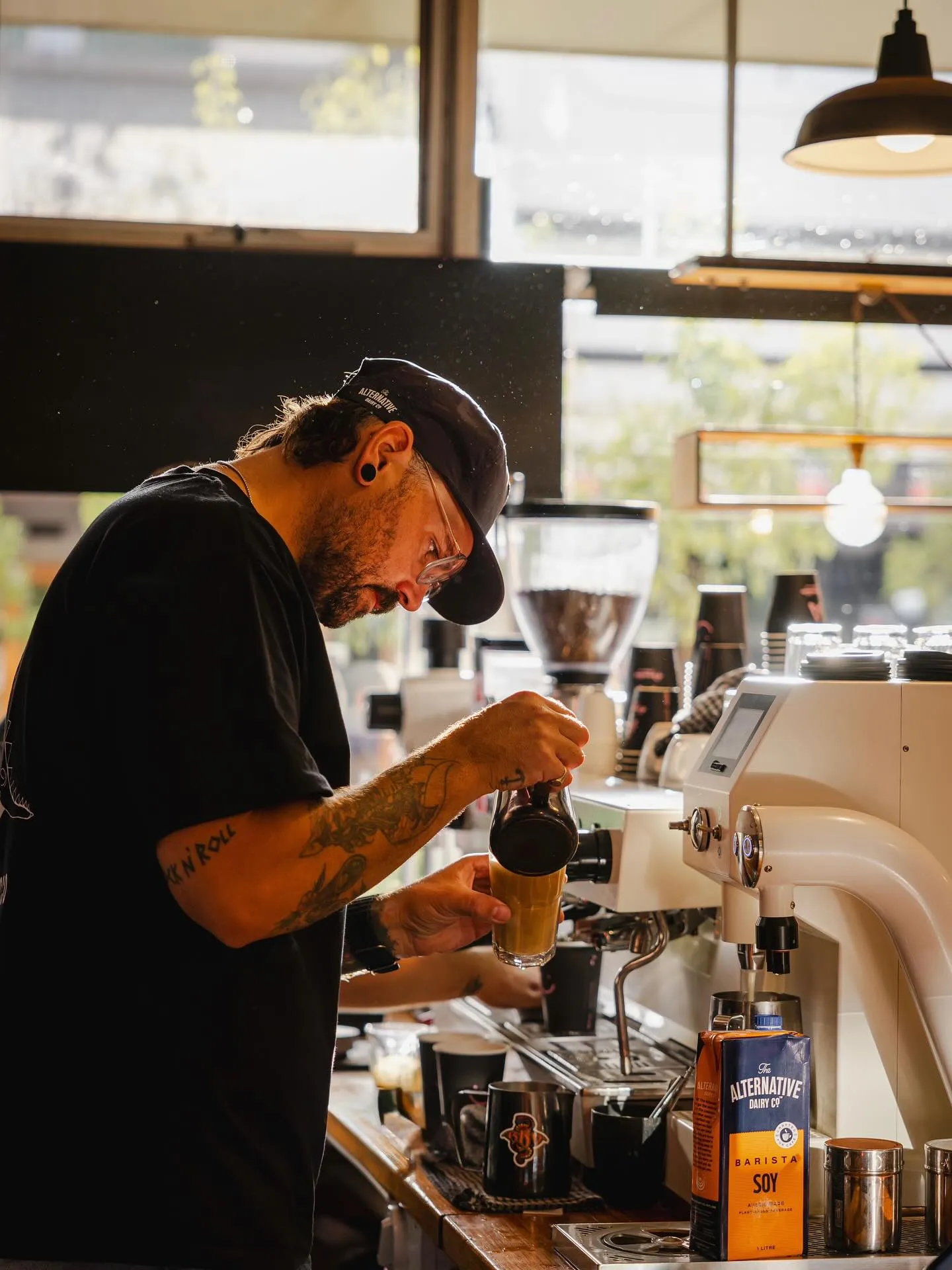 Barista focused on crafting a latte at the La Marzocco espresso machine
